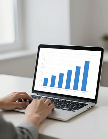 business, technology and internet concept - close up of woman with laptop computer and charts on...