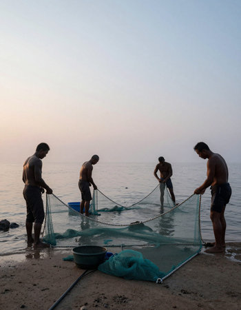 Fishermen are casting a net on the beach in the morning.の写真素材