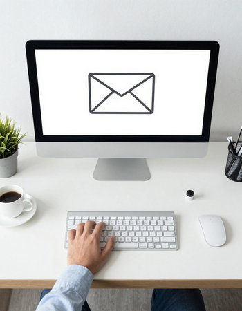 Man working on computer with email icon on screen. Business and communication concept.