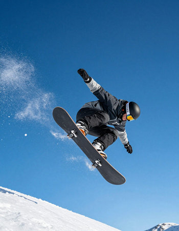 Flying snowboarder on mountains. Extreme winter sport. Copy space.