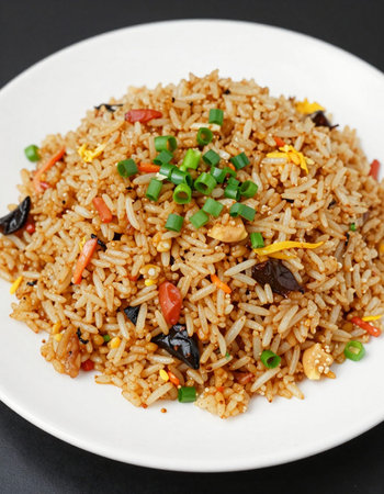Fried rice with vegetables in a white plate on a black backgroundの写真素材