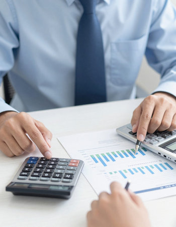 Business people discussing the charts and graphs showing the results of their successful teamworkの写真素材