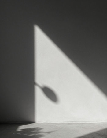 Shadow of the sun on a white wall. Light from the window.