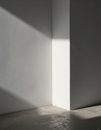 White wall with shadow on concrete floor. Light from the window.の写真素材
