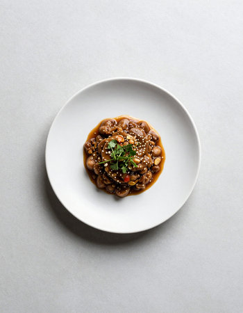Stir-fried mushrooms with sauce on white plate