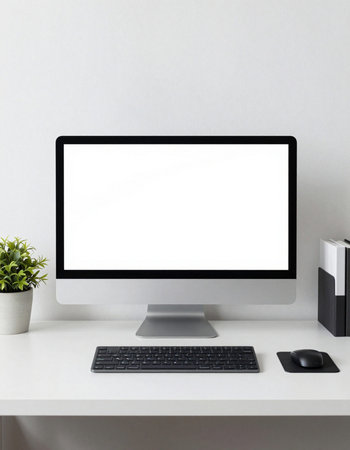 Modern desktop with blank screen computer, keyboard and mouse on white table.