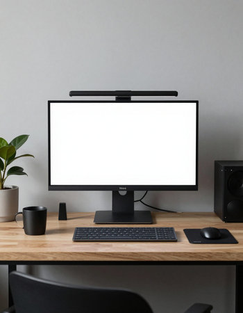 Computer with blank screen on wooden desk in modern office, stock photo