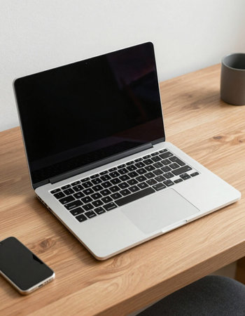 Laptop with blank screen on wooden table. Work from home concept.
