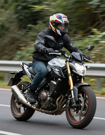 Man riding a motorbike on a country road. Motion blur.