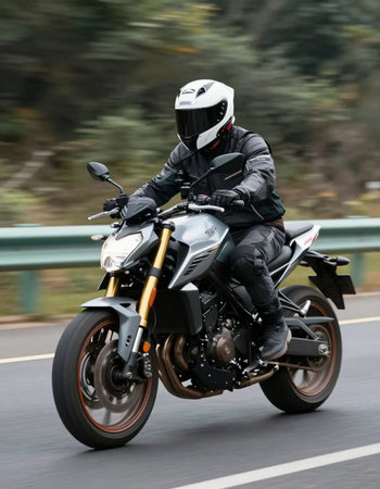 Riding a motorcycle on a highway in Spain. A motorcyclist in a black jacket and helmet.