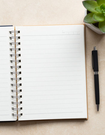 Notebook and pen on a table. Top view with copy spaceの写真素材