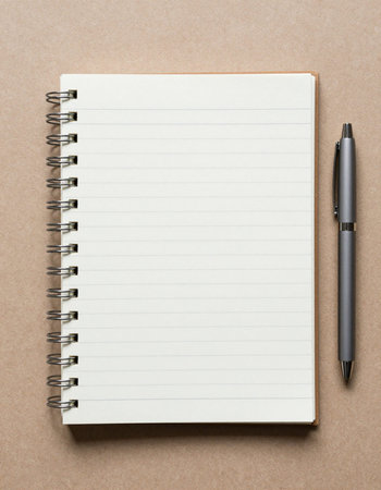 Notebook and pen on brown background. Top view with copy space