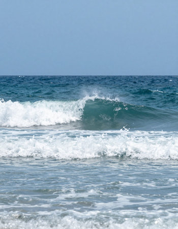 Sea wave on the beach, close-up, blue sky background