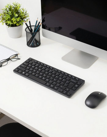 Top view of modern workplace with keyboard, mouse, notebook and pencils.