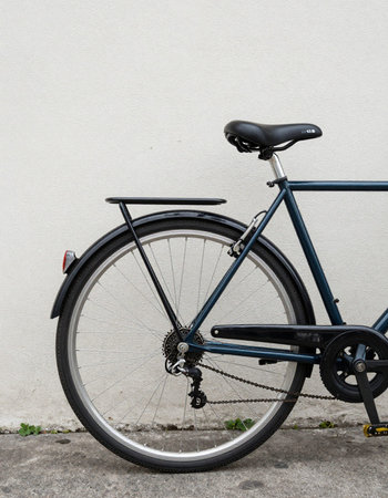 Bicycle in front of a white wall, closeup of photo