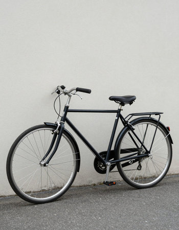 Bicycle in front of a white wall, with space for textの写真素材