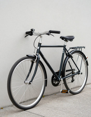 Bicycle leaning against a gray wall, with copy space for your textの写真素材