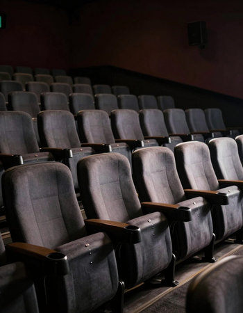 Empty cinema auditorium with rows of seats in a row, selective focus