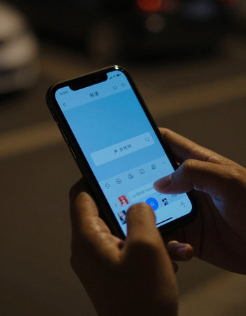Unidentified man using a smart phone.