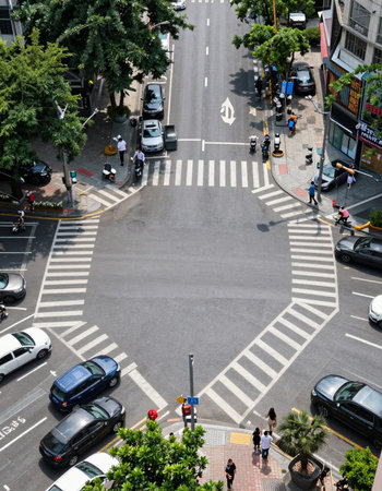 Hong Kong people and vehicles cross the street in Hong Kong.