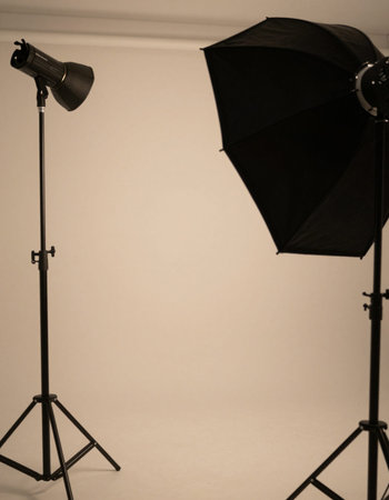 Photo studio equipment with softbox light and reflector on gray backgroundの写真素材