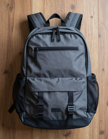 Black backpack on the wooden background. Backpack on the floor.