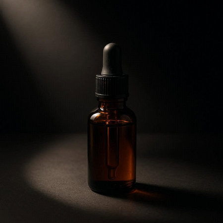 Amber glass dropper bottle with pipette on a black background