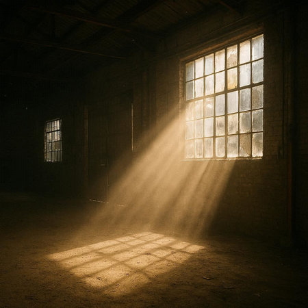 Abandoned factory interior with sunlight coming through the old window.