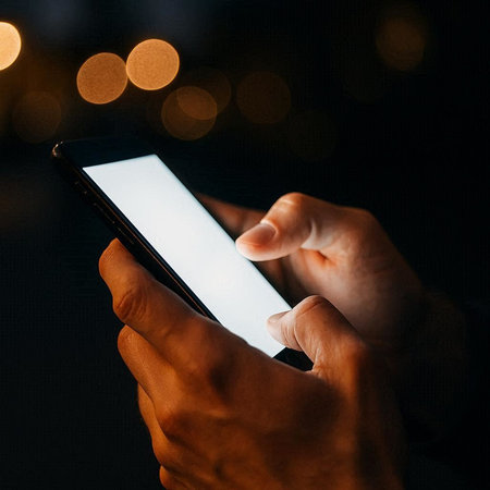 Close up of male hands using mobile smart phone with bokeh background