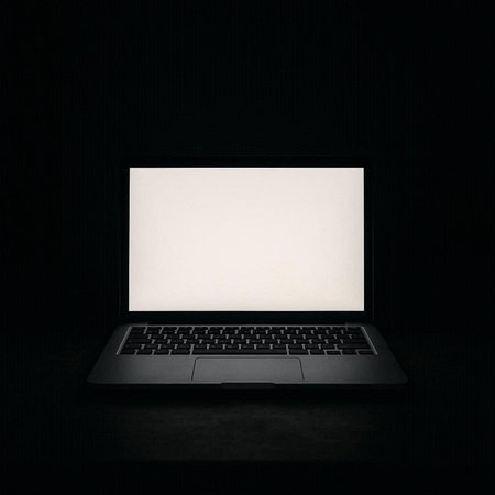 Laptop with blank screen isolated on black background. Mock up.