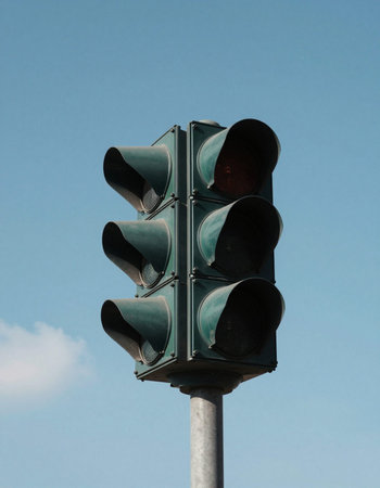 Traffic lights on a blue sky background, closeup of photo