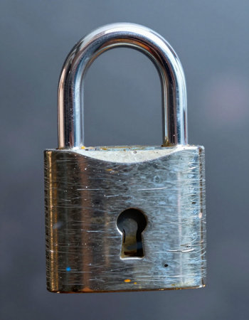 Close up of a locked padlock on a black background with copy space
