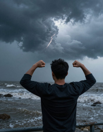 Man looking at the stormy sea with lightning in the sky.