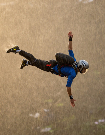 Skydiving in the mountains. Extreme sport. Free fall.
