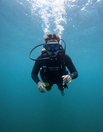 Scuba diver in deep blue sea with scuba mask and fins