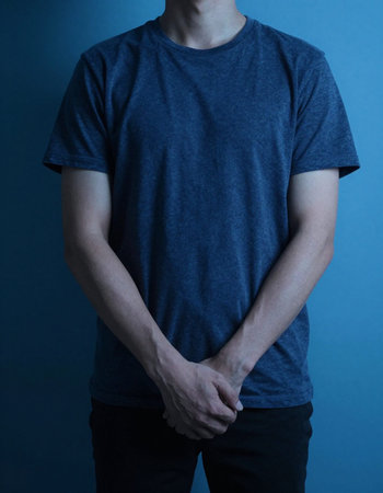 Man in a blue t-shirt on a blue background. Studio shot