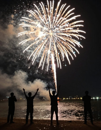 Silhouette of a group of young people and fireworks on the beach