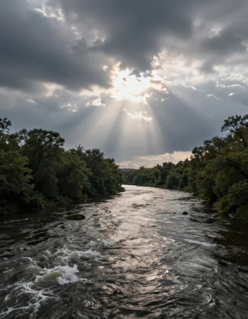 River landscape with sun rays shining through the clouds on a cloudy day