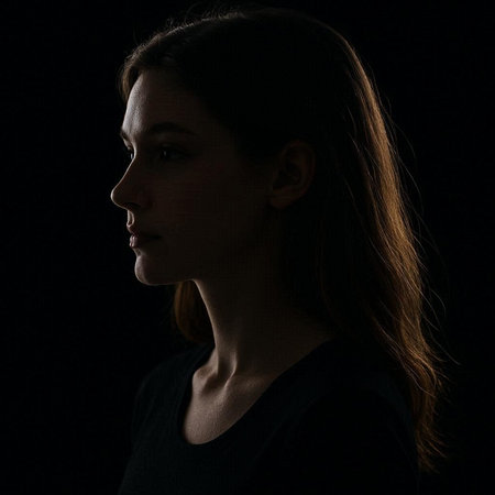 Portrait of a young woman on a black background. Studio shot.