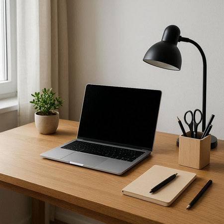 Laptop with blank screen mockup and stationery on wooden table