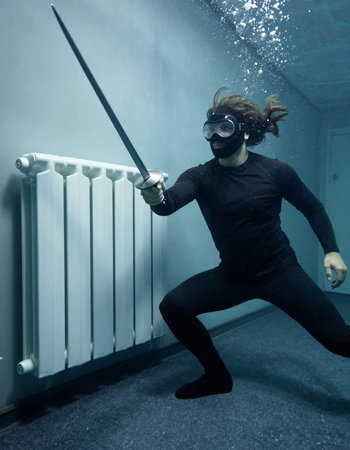 Young man with mask and sword in the dark. Halloween theme.