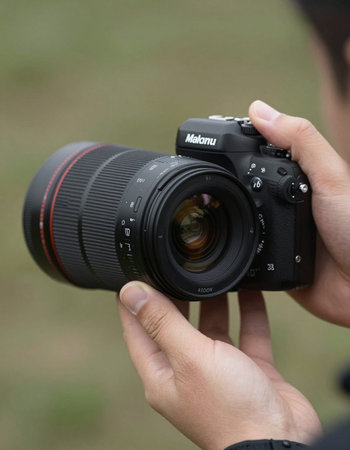 A man holding a DSLR camera in front of his camera.