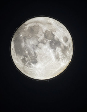 Full moon at night in the dark sky. View from above.