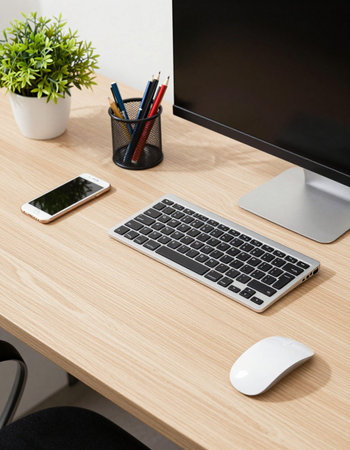Close-up of a workplace with keyboard, mouse, pencils and mobile phone