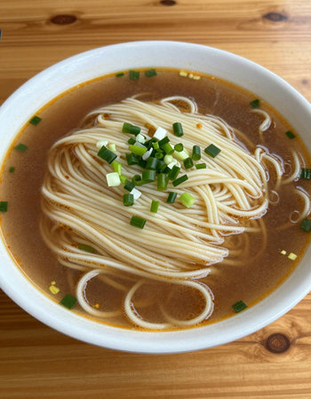 Japanese ramen noodle soup in bowl on wooden table, top view