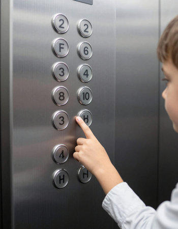 Close up of child pressing the elevator button. Focus on hand.