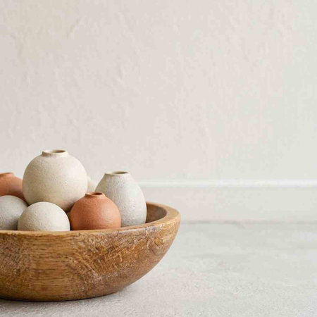 Eggs in a wooden bowl on a white background. Copy space.