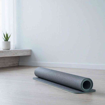 Yoga mat on the floor in the room. Fitness and healthy lifestyle concept.