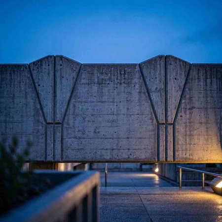 Concrete wall of a modern building in the evening at night.
