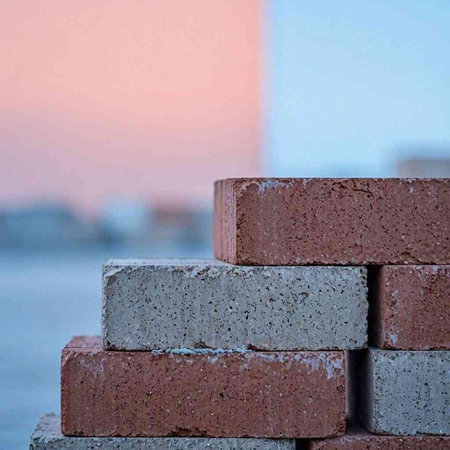 Stack of bricks on the construction site, close-up, selective focus